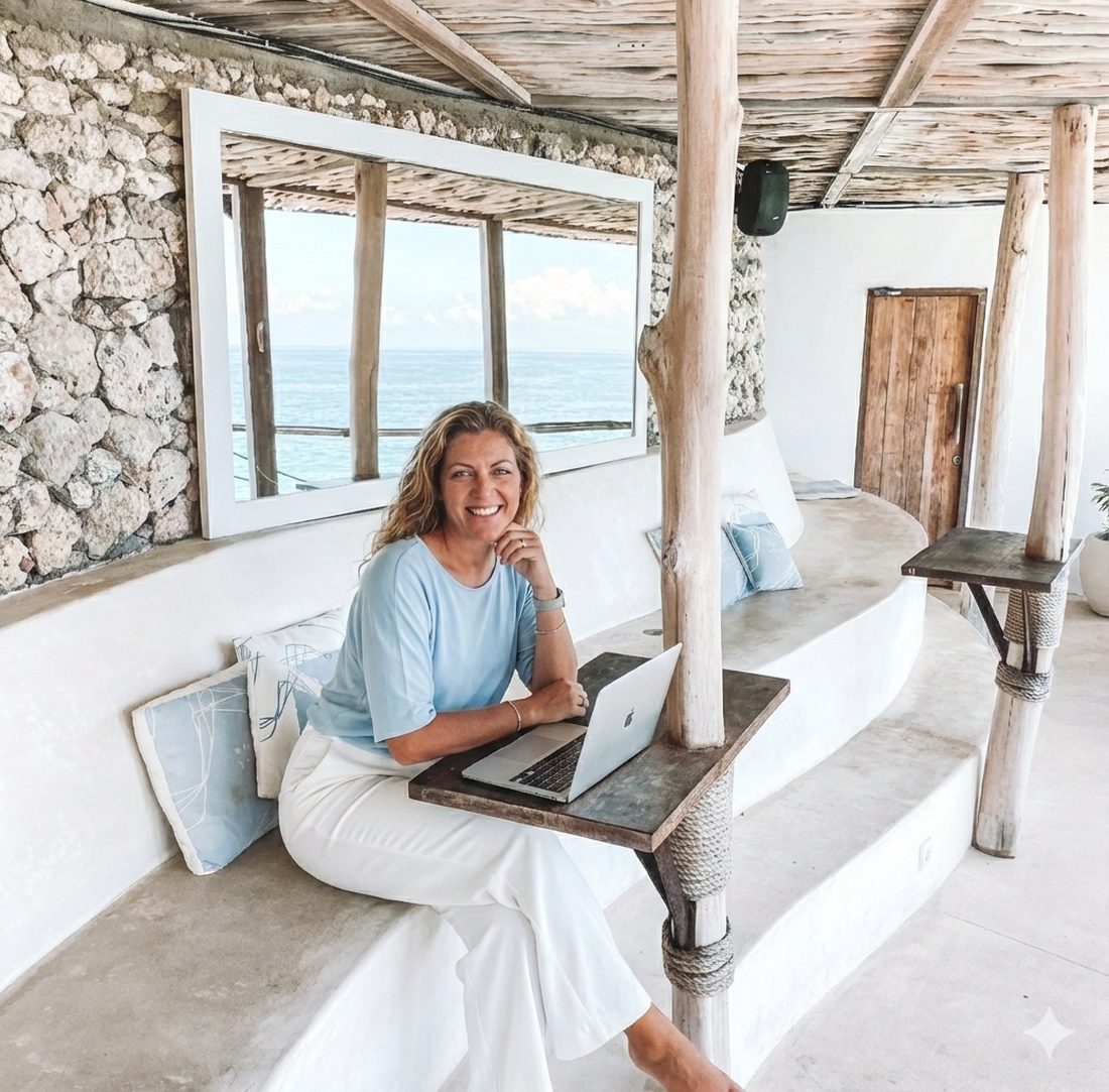 Verena at a table with her laptop, smiling
